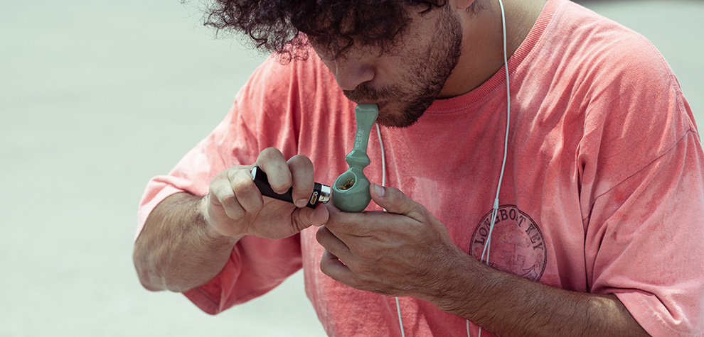 Man using a pipe to smoke moon rock weed from MMJ Express online dispensary Canada. moon rocks for sale.