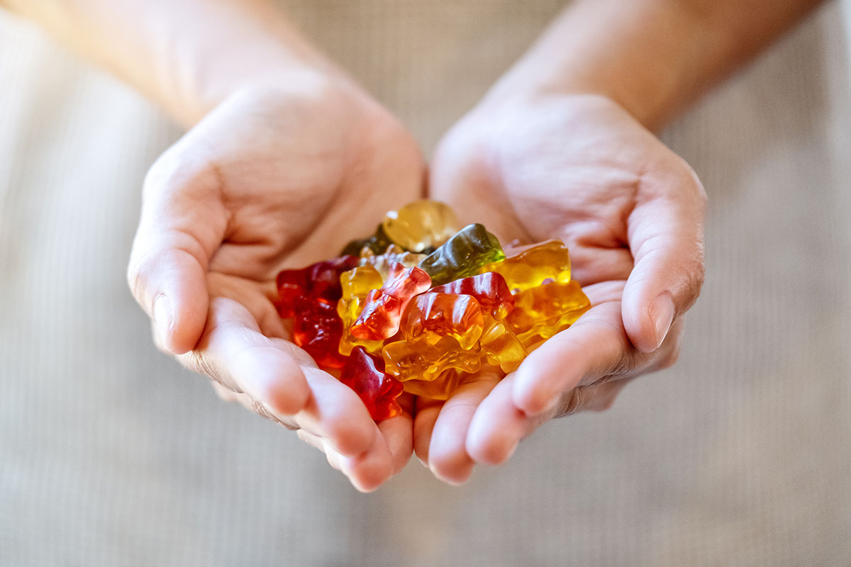 edible weed gummies held in a persons palms. BC weed. dispensary. mail order marijuana Canada.