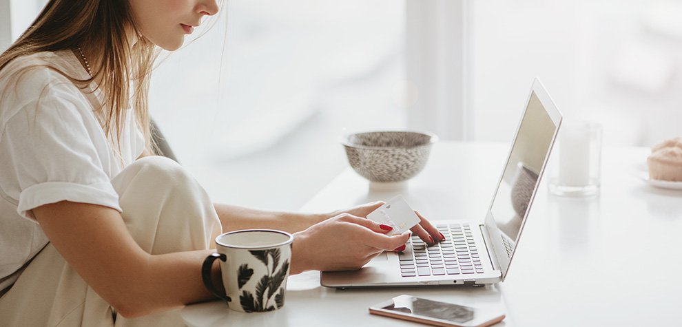 Woman on laptop buying weed online in Canada at dispensary for BC cannabis.Order weed online.