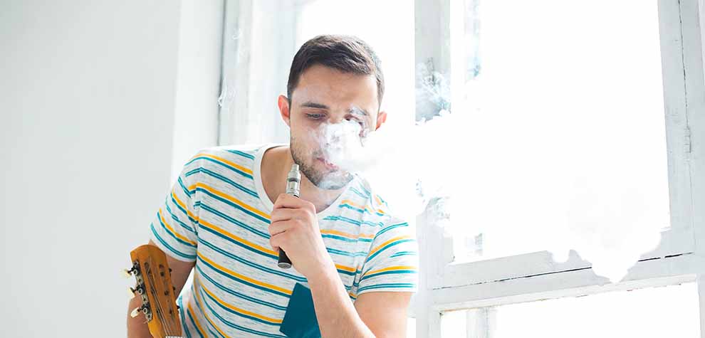 Man enjoying smoking dabs without a rig. how to smoke dabs. buy shatter weed and shatter concentrates online at MMJ Express online weed dispensary for mail order marijuana Canada.