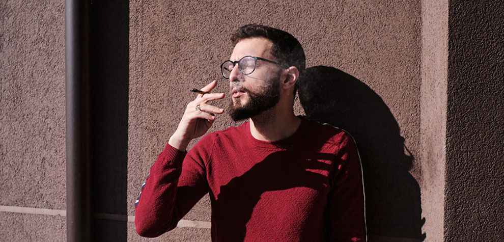 Man smoking a joint of pink tuna strain weed from an online dispensary in Canada. online dispensary canada to buy weeds online. cannabis canada. Dispencary.