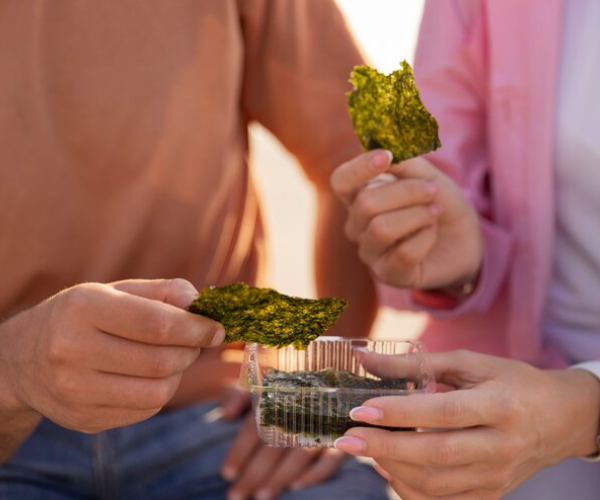 Two people sharing cannabis edibles, symbolizing quality products and service from a proper online pot delivery dispensary