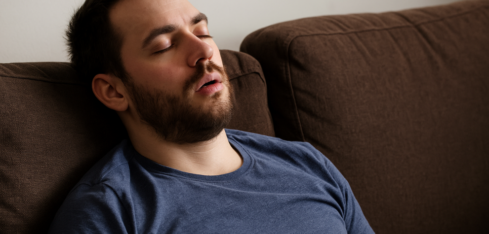 Man asleep on a couch, suggesting the heavy, relaxing effects of the Astro Pink strain