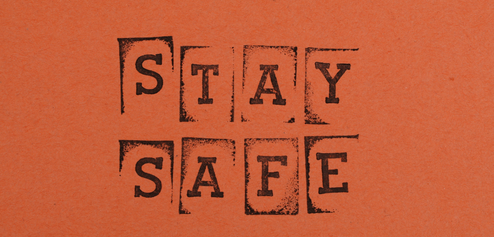 Text reading “STAY SAFE” on an orange background, symbolizing tips for safe cannabis shopping in Canada